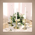 Tall white taper candles on an elegant table