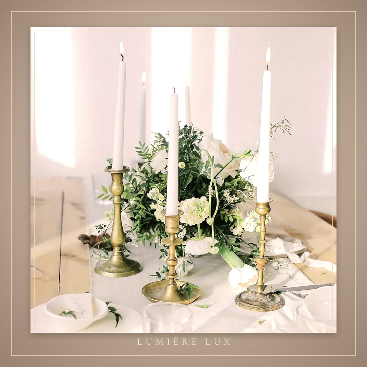 Tall white taper candles on an elegant table