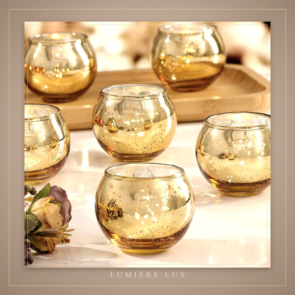 Gold tealight holders glowing on a table